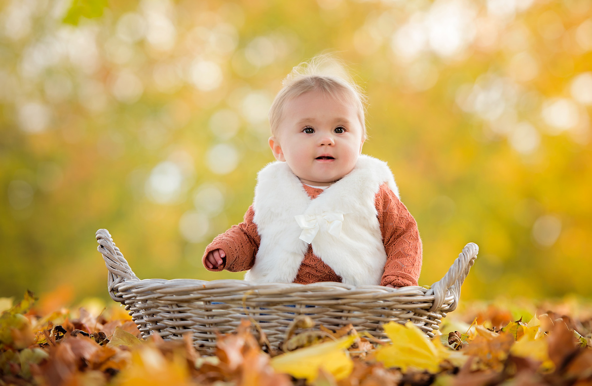 Baby in the autumn leaves