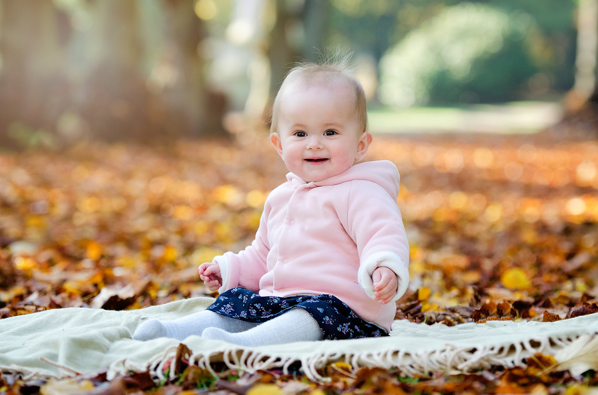 Baby in the autumn leaves