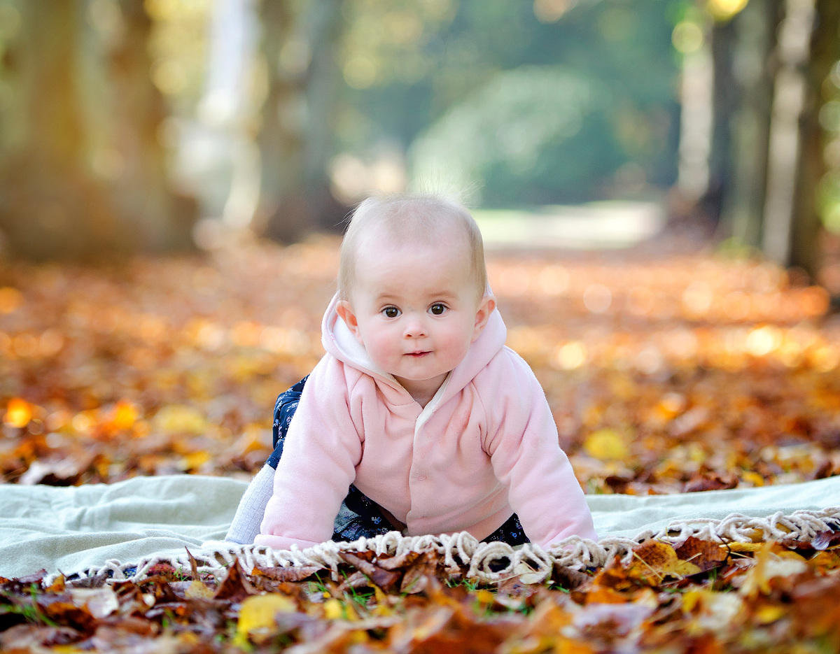 Baby in the autumn leaves