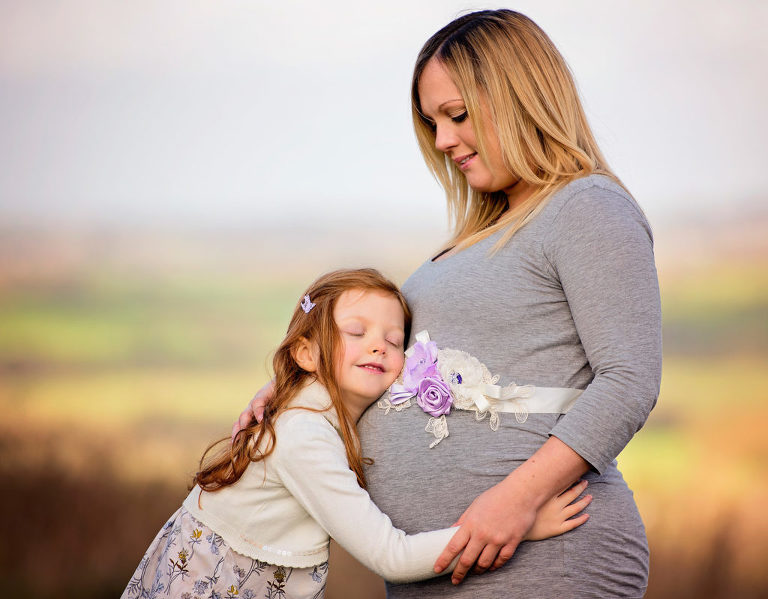 Mum enjoying maternity photo shoot with daughter