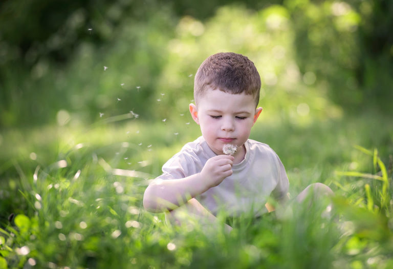 Little boy playing in field